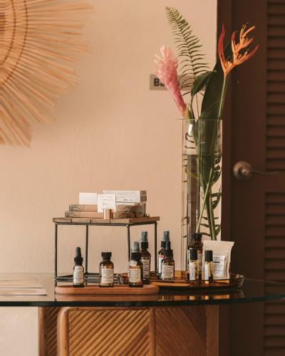 a table with a vase and a shelf with bottles on it at Casa Grande Mountain Retreat - Adults Only in Utuado