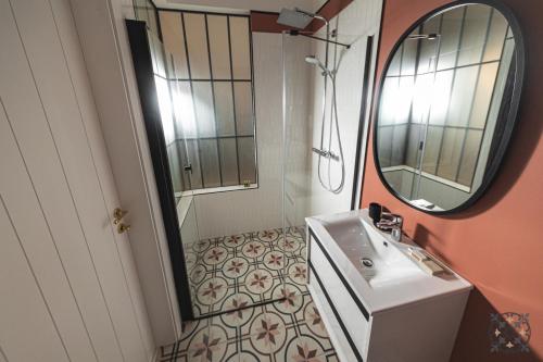 a bathroom with a sink and a mirror at Villa Chez les Amis - Adults only in Balatonszepezd