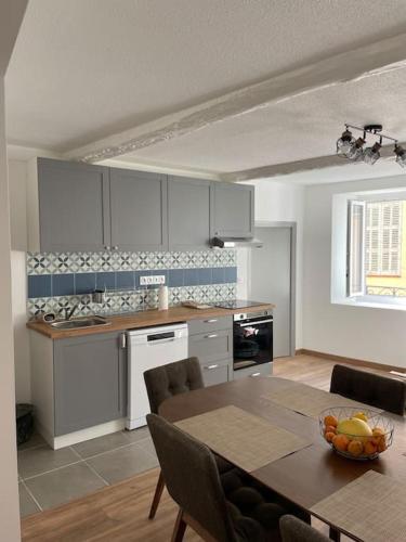a kitchen with a table and a dining room at Grand appartement hyper centre Grasse in Grasse
