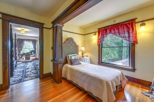 a bedroom with a bed and a large window at Historic Auburn House on 37 Acres with Private Lake! in Auburn