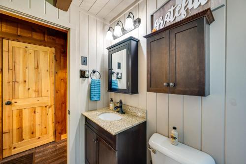 a bathroom with a sink and a toilet at North Haverhill Cabin with Fire Pit and Grill! 