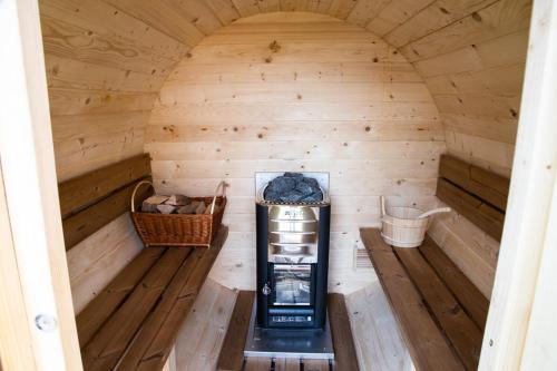 an inside view of a sauna with a refrigerator and baskets at DOMEK NA WIERCHACH in Piwniczna-Zdrój