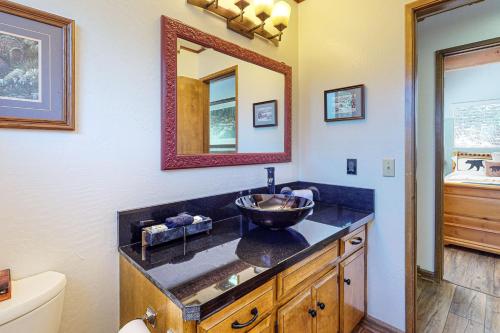 a bathroom with a sink and a mirror at House of the Rising Sun in Lake Arrowhead