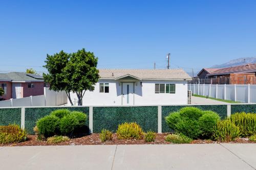 a white fence in front of a house at Cozy and Quiet Front House in Fontana