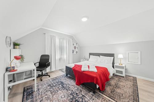 a white bedroom with a bed with a red blanket at Close to mall with private toilet, Free Wi-Fi and Parking in Toronto