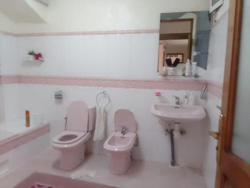 a bathroom with a toilet and a sink at إقامة الصداقة in Larache