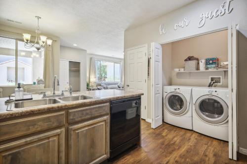 a kitchen with a sink and a washer and dryer at Welcoming Mesquite Condo with Pool Access! in Mesquite