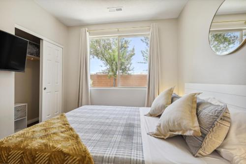 a bedroom with a bed with pillows and a window at Welcoming Mesquite Condo with Pool Access! in Mesquite