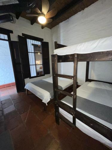 two bunk beds in a room with a window at Hotel Colonial Palmira in Palmira