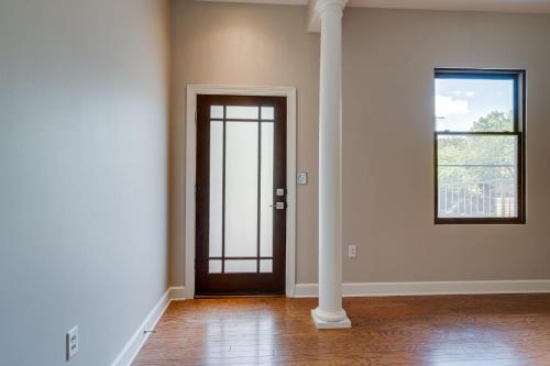 an empty room with a door and a window at Historic Edgefield 2bd 2ba Loft in Nashville