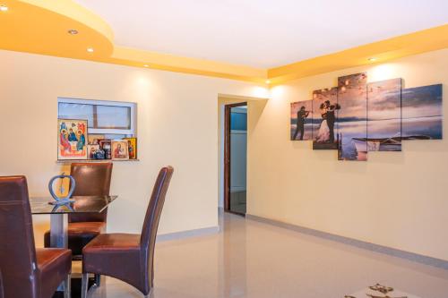 a dining room with a table and some pictures on the wall at Pensiunea Aura in Murighiol