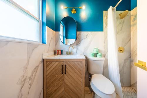 a bathroom with a toilet and a sink and a mirror at Tropical Breeze in Clearwater Beach