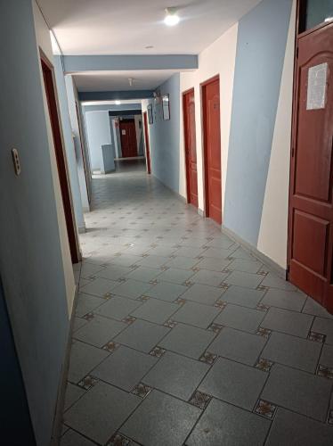 an empty hallway of a building with a hallway at HOTEL MAJESTIC ZARUMILLA in Zarumilla