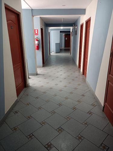 an empty hallway of a building with a hallwayngth at HOTEL MAJESTIC ZARUMILLA in Zarumilla
