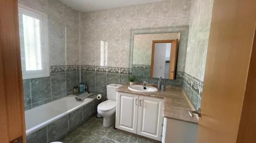 a bathroom with a sink and a tub and a toilet at Casa Sol & Mar, Rincon de la Victoria, Malaga in Rincón de la Victoria