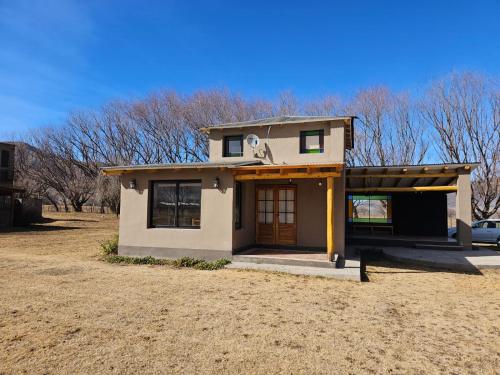 uma pequena casa num campo com um quintal em Sonko em Tafí del Valle