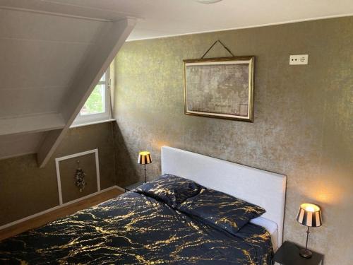 een slaapkamer met een bed en een schilderij aan de muur bij B&B Erve Möskert in Geesteren