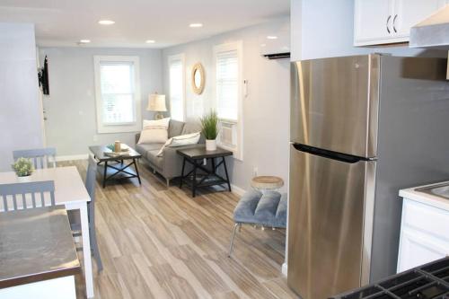 a kitchen and living room with a stainless steel refrigerator at The Clark - Suite 1E - Ocean Grove near Asbury in Ocean Grove