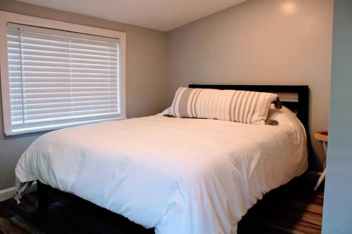 a bedroom with a large white bed with a window at The Clark - Suite 1E - Ocean Grove near Asbury in Ocean Grove