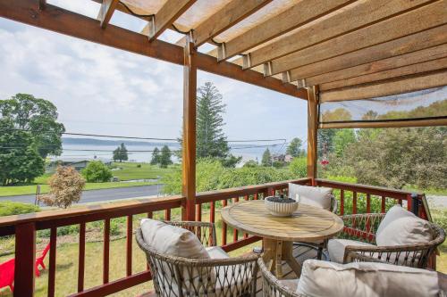 a patio with a table and chairs on a deck at Crystal Lake Vacation Rental, 3 Mi to Betsie River in Beulah