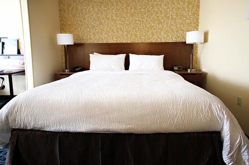 a bedroom with a large white bed with two lamps at Fairfield Inn & Suites by Marriott London in London