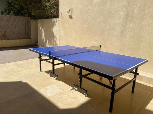 a blue ping pong table sitting on a patio at La Villa Toscana: Pool & Elah Valley vineyard view in Adderet