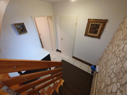 a staircase leading up to a room with a door at Ferienhaus Regina im Bohnental in Lebach