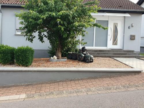 a toy car sitting in front of a house at Ferienhaus Regina im Bohnental in Lebach