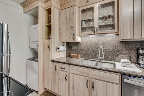 a kitchen with wooden cabinets and a sink at Interlude Condominiums 2-Bedroom Unit 204 in Snowmass Village