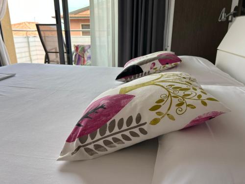two pillows sitting on top of a bed at Gardesana Active Apartments in Malcesine