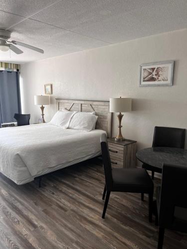 a bedroom with a bed and a table and chairs at David's Landing in Myrtle Beach
