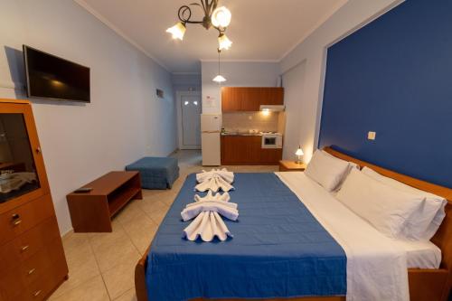 a hotel room with a bed with towels on it at Studio Konstantinos in Parga