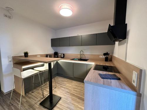 a kitchen with a table and a counter top at Stilapartment Oasis 1 #Whirlpool saisonal in Wernigerode