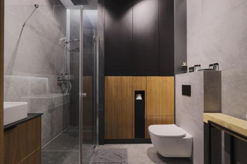 a bathroom with a shower and a toilet and a sink at Apartament 1N2 taras z widokiem - Sun&Sport in Szczyrk