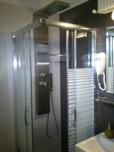 a shower stall in a bathroom with a sink at Aenaon Studios in Oreoí