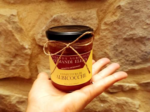 a person holding up a jar of mustard at Pian di Rocca Country in Castiglione della Pescaia