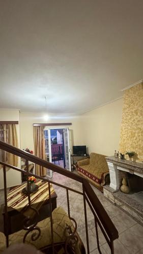 a living room with a bed and a fireplace at Kali’s comfort in Karavomylos