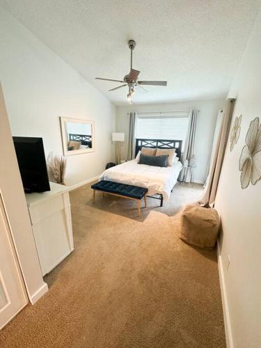 a bedroom with a bed and a flat screen tv at Modern Rocket City Condo -- 3 min to Mid-City in Huntsville