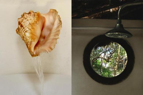 a sandwich hanging on a wall next to a mirror at Coco Tulum Hotel in Tulum