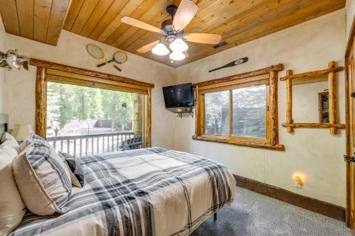 a bedroom with a bed and a ceiling fan at Weber River Cabin in Oakley with Private Hot Tub! in Oakley