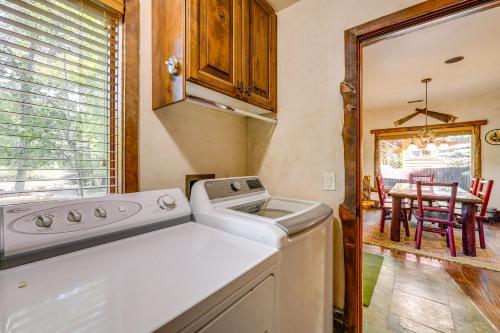 a kitchen with a washing machine and a dining room at Weber River Cabin in Oakley with Private Hot Tub! in Oakley