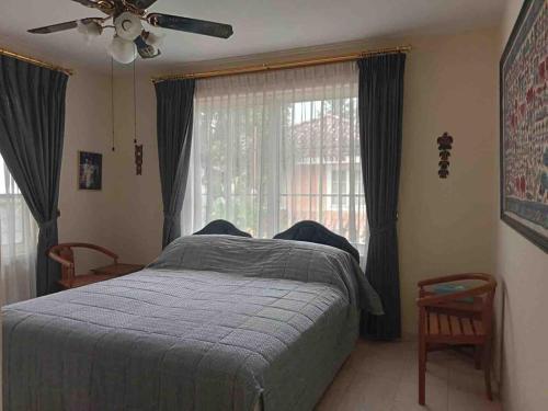 a bedroom with a bed in front of a window at Private Villa with Swimming Pool in Babakan Madang