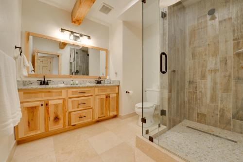 a bathroom with a shower and a toilet and a sink at 23 Mi to Targhee Skiing Felt Cabin with Hot Tub! in Felt