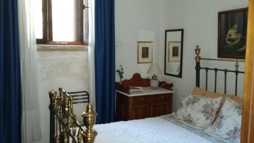 a bedroom with a bed and a desk with a mirror at Olive Cottage in Kyparissia
