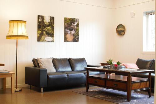 uma sala de estar com um sofá de couro e uma mesa em Sognhostel em Sørbø