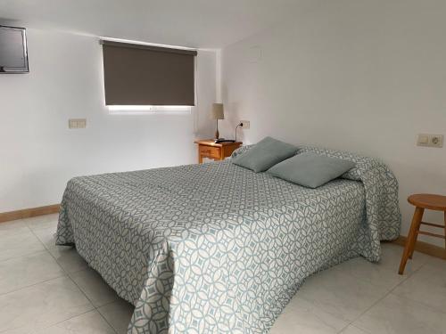 Posteľ alebo postele v izbe v ubytovaní Apartamentos OLIVA