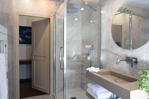 a bathroom with a shower and a sink and a mirror at L'Hostalet in Argelès-sur-Mer