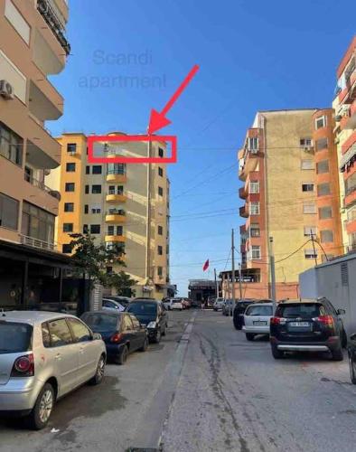 a street filled with parked cars in a city at Scandi Apartaments in Durrës