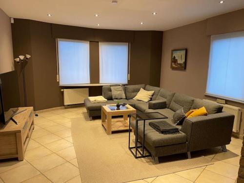a living room with a couch and a table at Wilgentuin in Bekkevoort
