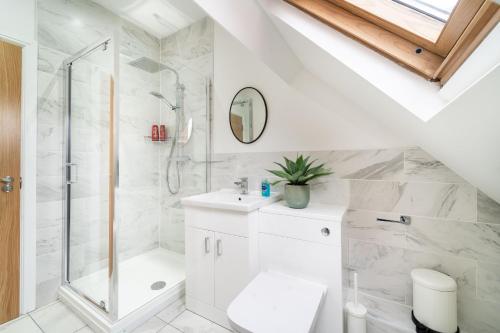 a white bathroom with a shower and a toilet at 8 The Quadrant Luxury Apartments - Hoylake in Hoylake